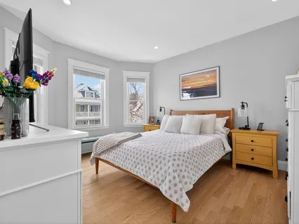 a bedroom with a bed and a dresser