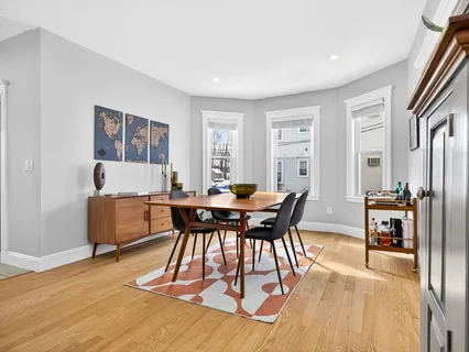 a view of a dining room with furniture and wooden floor