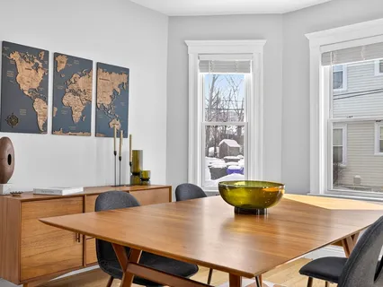 a view of a dining room with furniture and wooden floor
