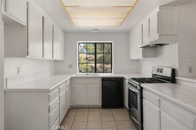 a kitchen with a sink stove and cabinets