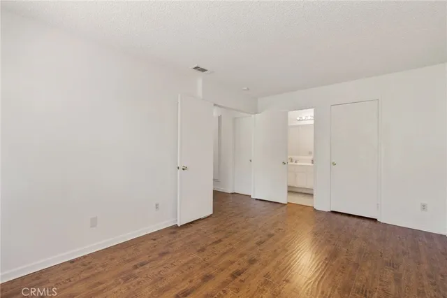 a view of an empty room and wooden floor