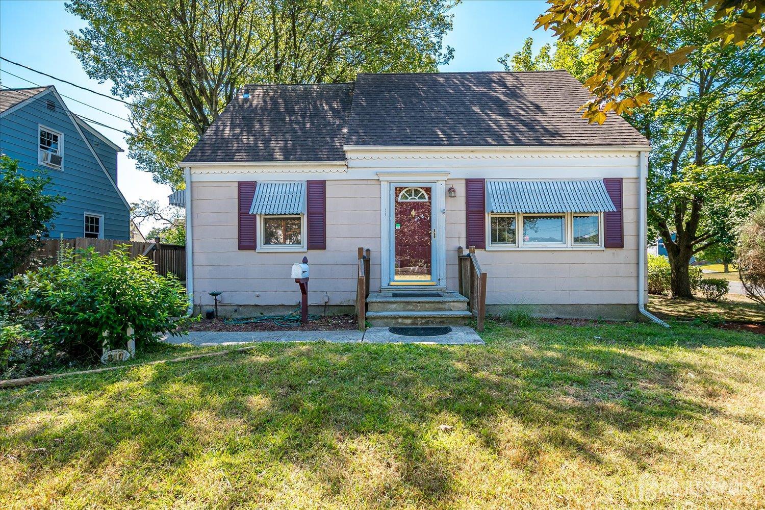 a house that has a small yard and large trees