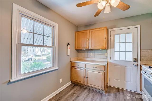 a kitchen with stainless steel appliances granite countertop a sink refrigerator and cabinets