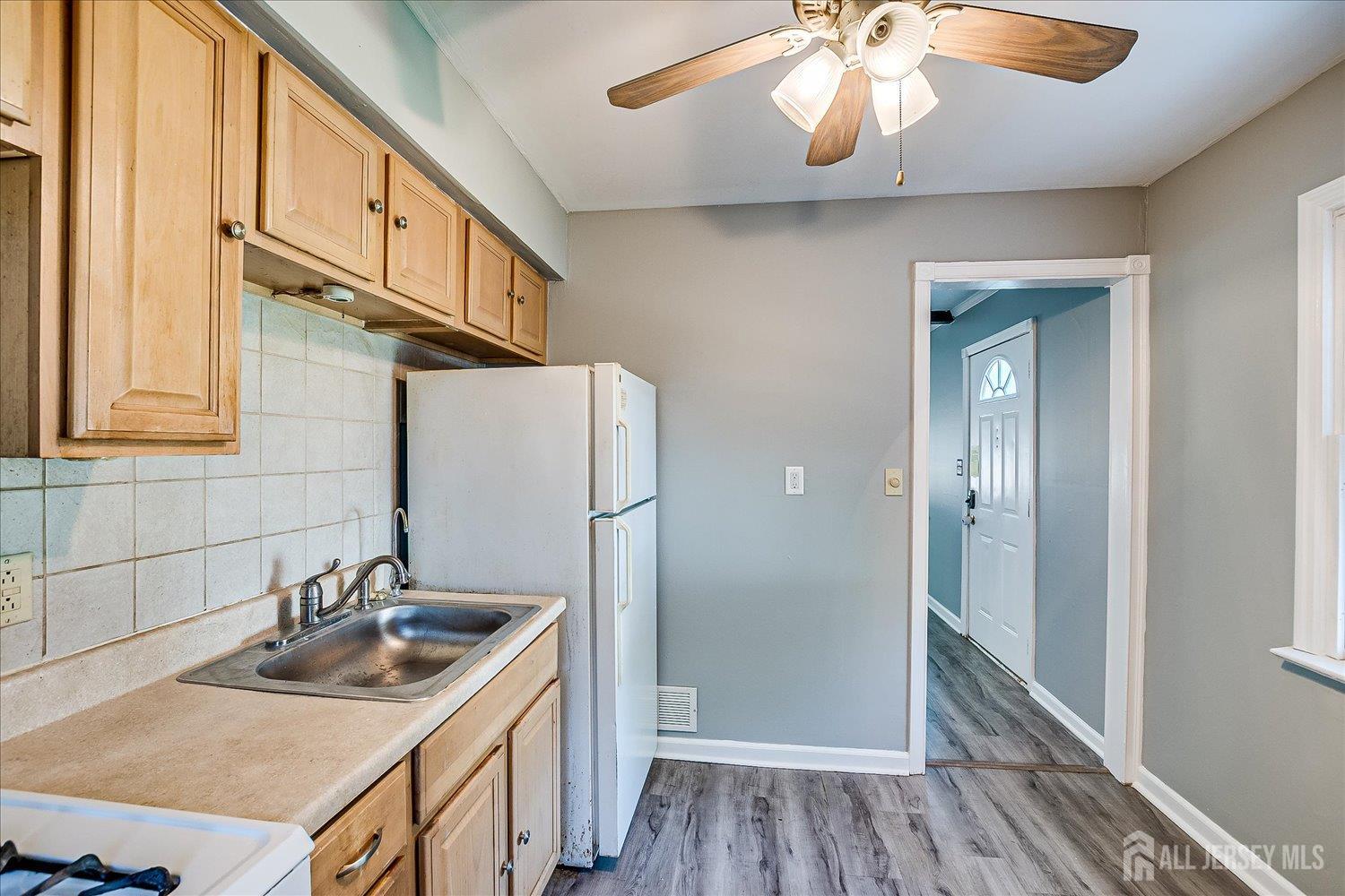 310 Howard Avenue Middlesex, NJ 08846 - Photo 15 of 42 a kitchen with stainless steel appliances granite countertop a sink refrigerator and cabinets
