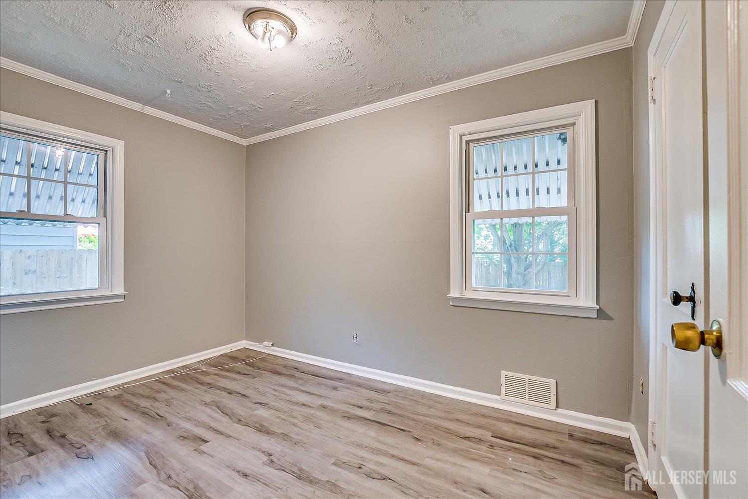 310 Howard Avenue Middlesex, NJ 08846 - Photo 18 of 42 a view of an empty room with wooden floor and a window