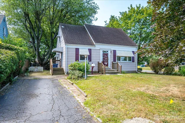 a view of a house with backyard and sitting area