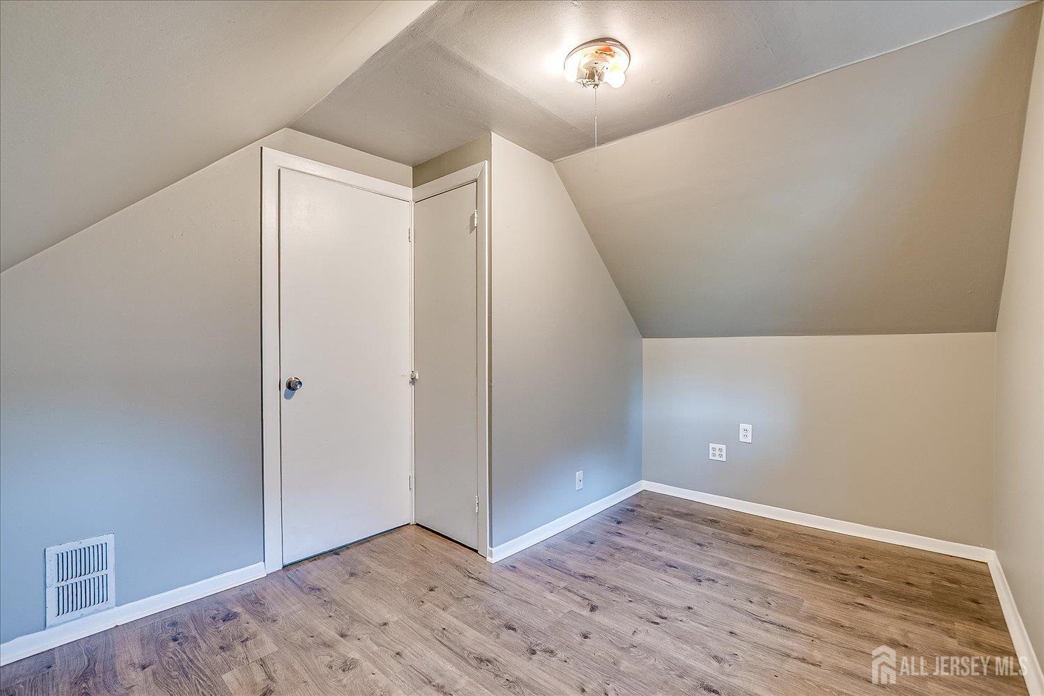 310 Howard Avenue Middlesex, NJ 08846 - Photo 21 of 42 an empty room with wooden floor and windows