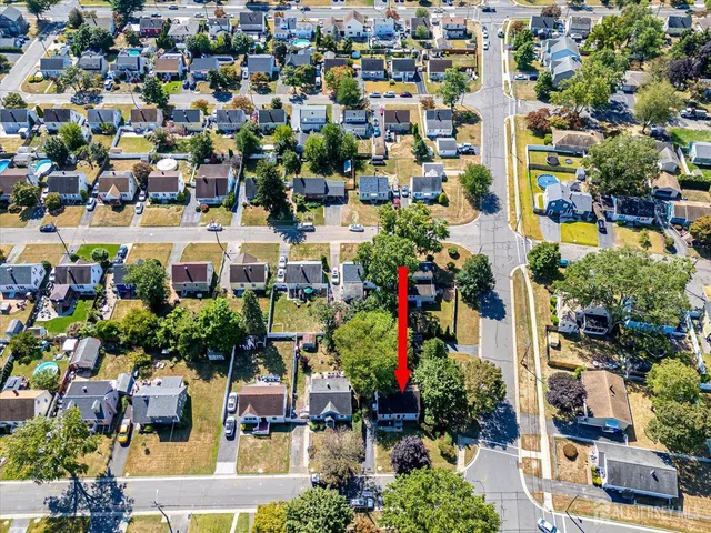an aerial view of residential houses with outdoor space
