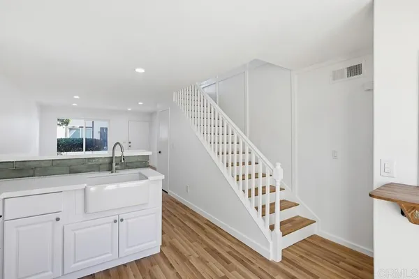 a view of entryway and hall with wooden floor