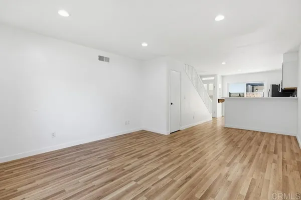 a view of a kitchen with wooden floor and a sink