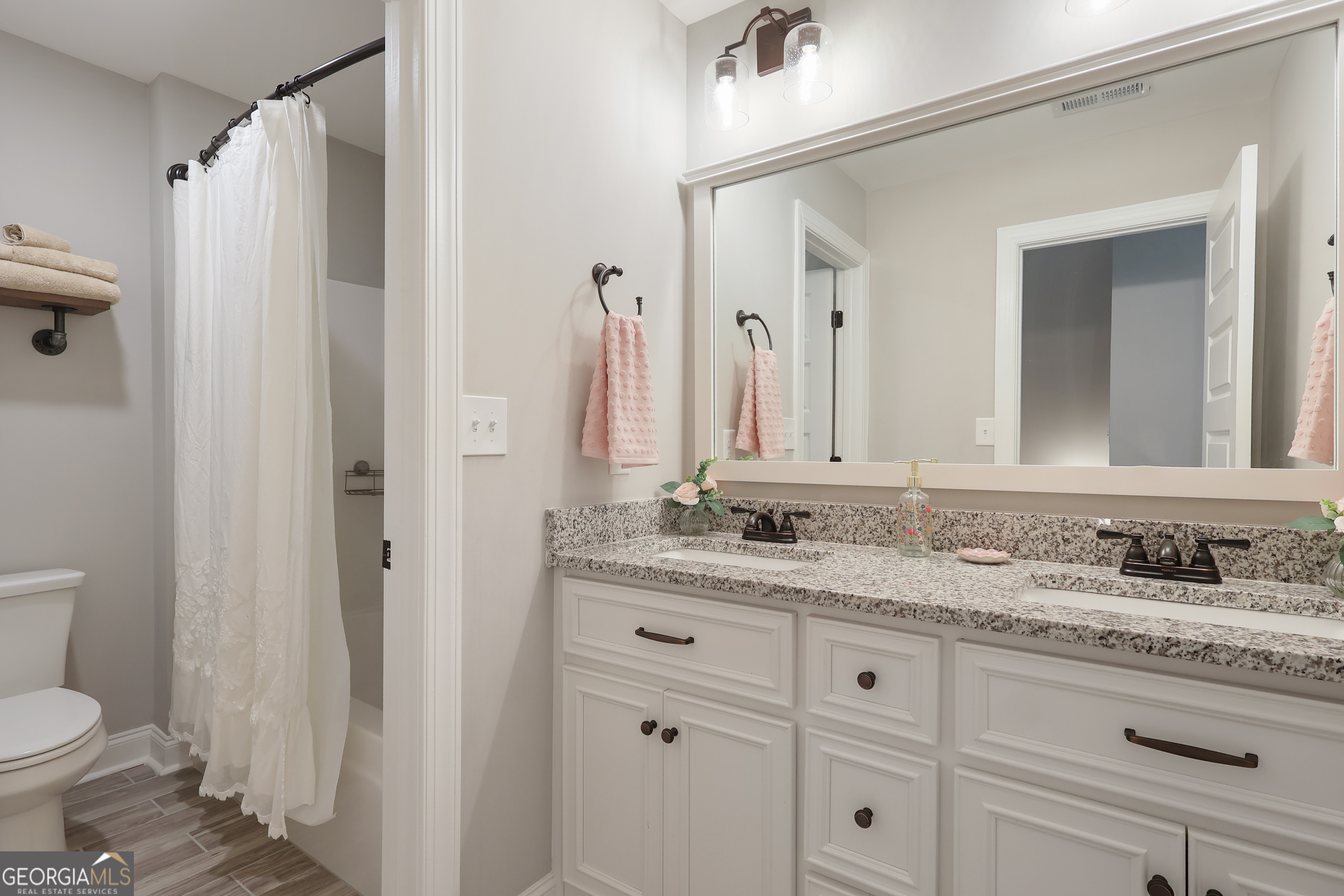 89 Claire Road Forsyth, GA 31029 - Photo 28 of 40 a bathroom with a granite countertop sink and a mirror