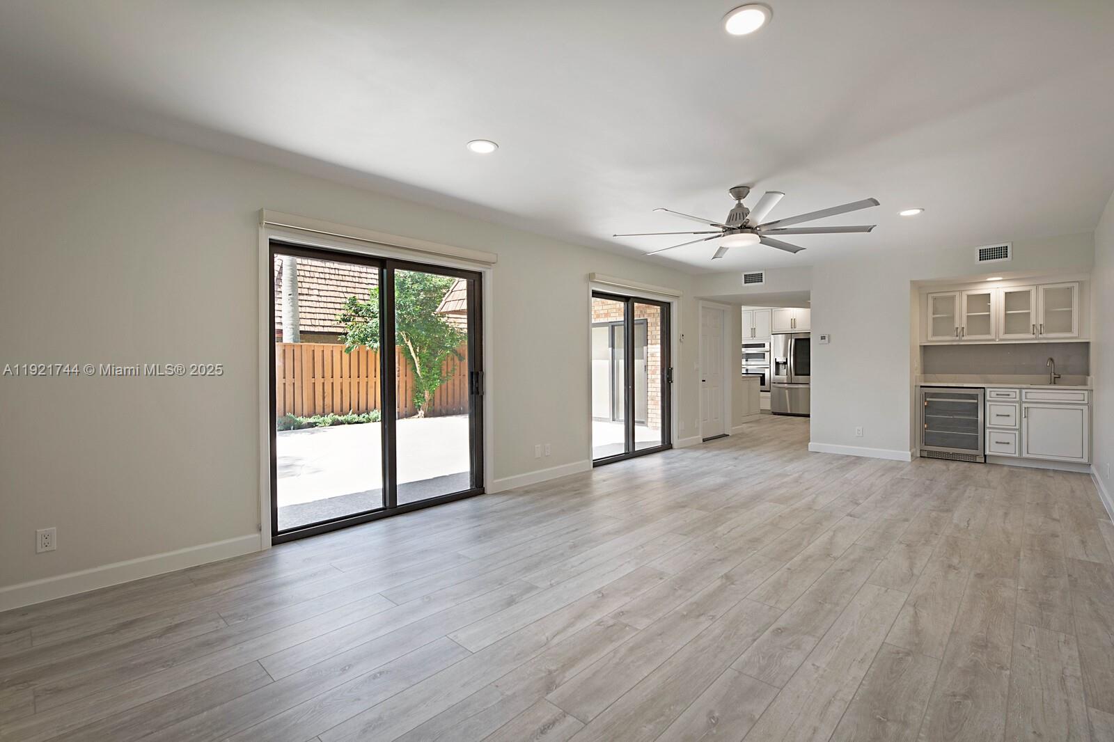 1420 Ocean Way, Unit 19D Jupiter, FL 33477 - Photo 14 of 34 a view of an empty room with a window and wooden floor