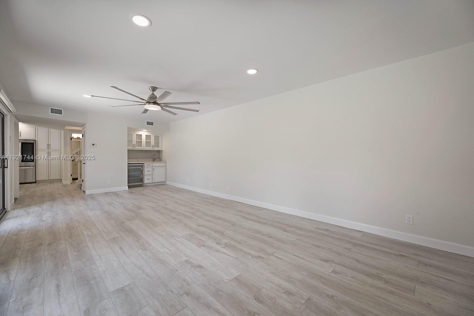 1420 Ocean Way, Unit 19D Jupiter, FL 33477 - Photo 15 of 34 wooden floor in an empty room with a window