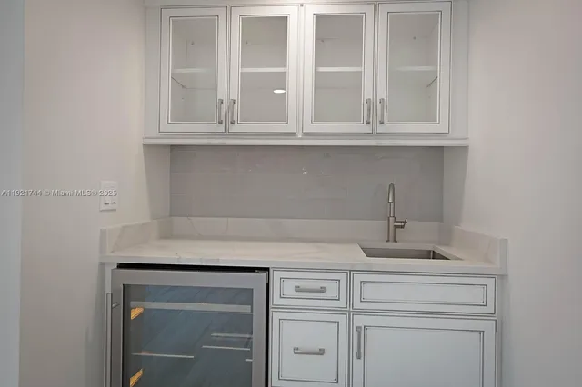 a sink with white cabinets