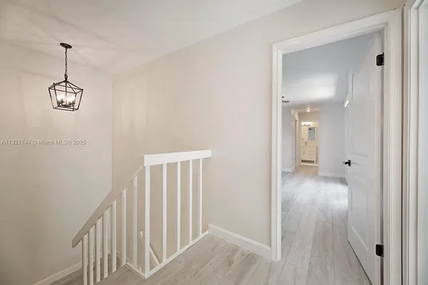a view of a hallway view with wooden floor and staircase