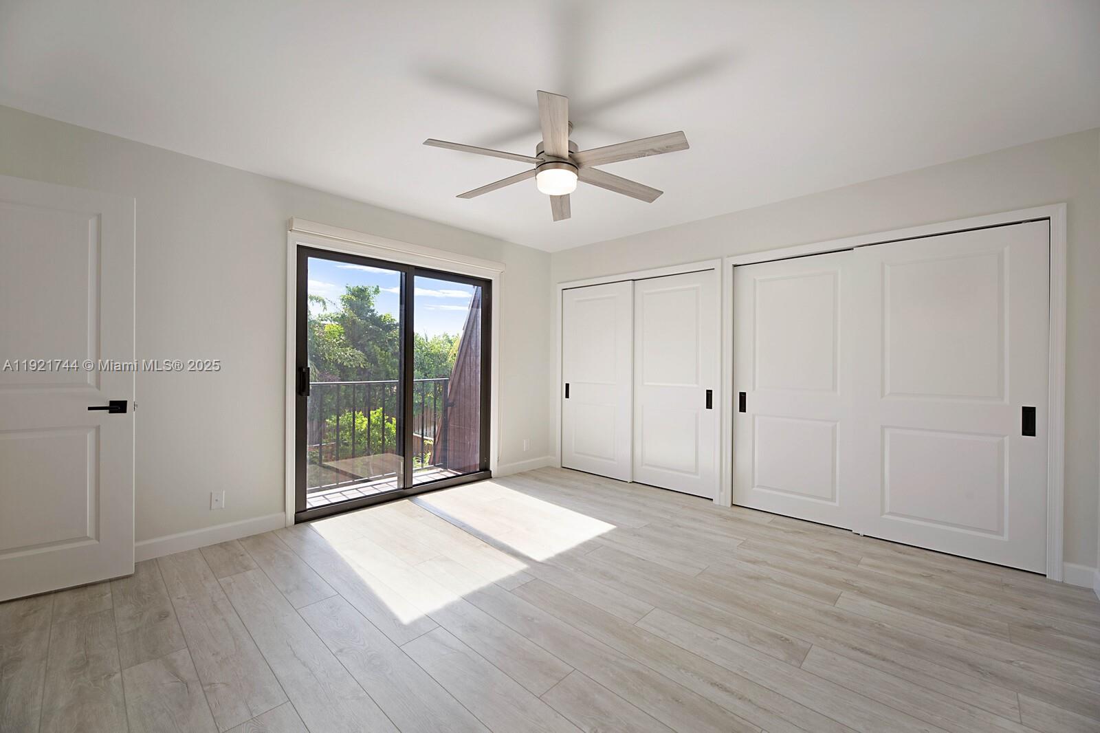 1420 Ocean Way, Unit 19D Jupiter, FL 33477 - Photo 26 of 34 an empty room with wooden floor and windows