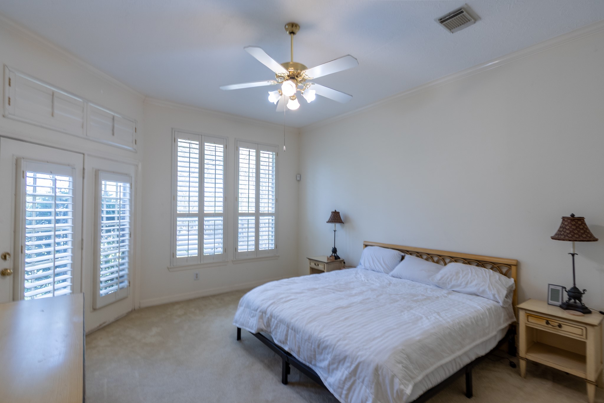5718 Oakmoss Trail Spring, TX 77379 - Photo 28 of 50 Spacious primary suite with soaring ceilings and tranquil backyard views — your private retreat.
