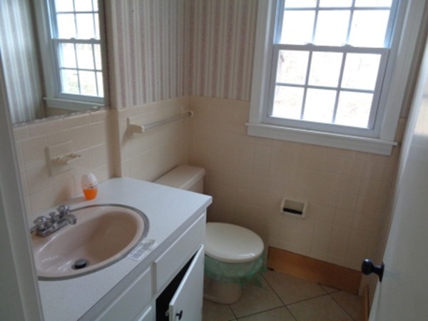 944 Maple Road Longmeadow, MA 01106 - Photo 7 of 11 a bathroom with a sink a toilet and a window