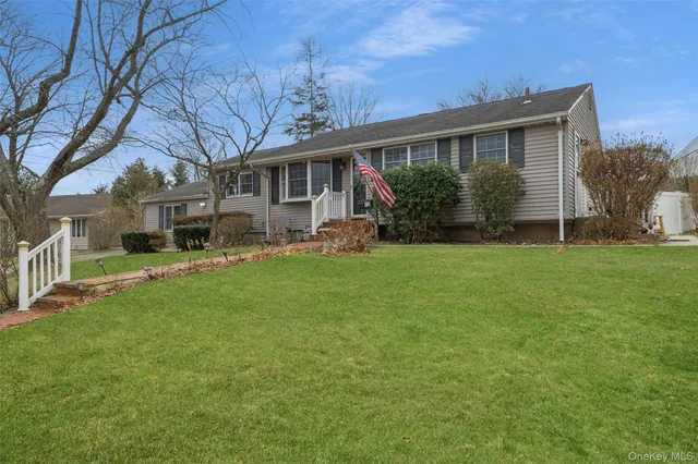 a front view of house with yard and green space