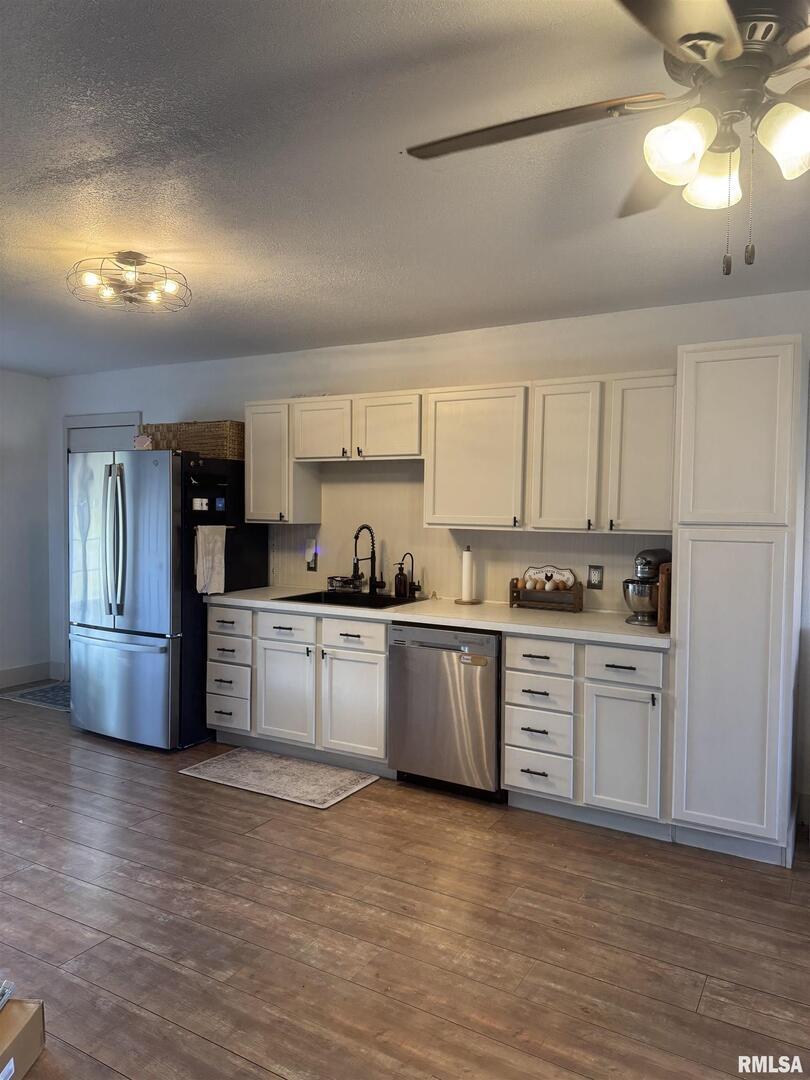 16379 Sand Road Fulton, IL 61252 - Photo 3 of 27 a kitchen with granite countertop white cabinets and white stainless steel appliances