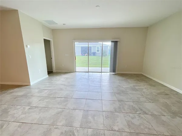 a large kitchen with stainless steel appliances a refrigerator a stove a sink a table and chairs