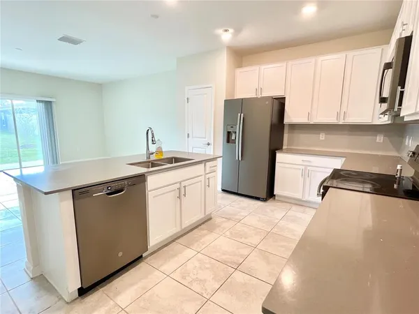 a bathroom with a double vanity sink mirror and shower