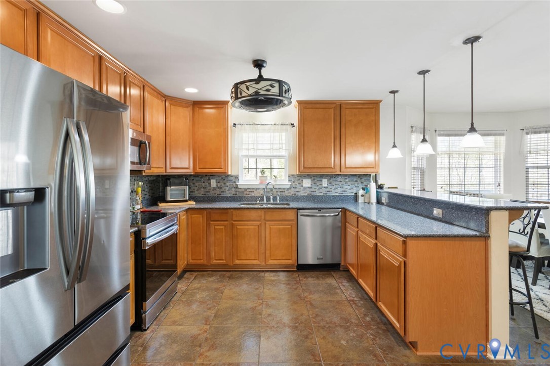 15650 River Road Chesterfield, VA 23838 - Photo 11 of 50 a kitchen with stainless steel appliances granite countertop a refrigerator a sink a stove and a microwave