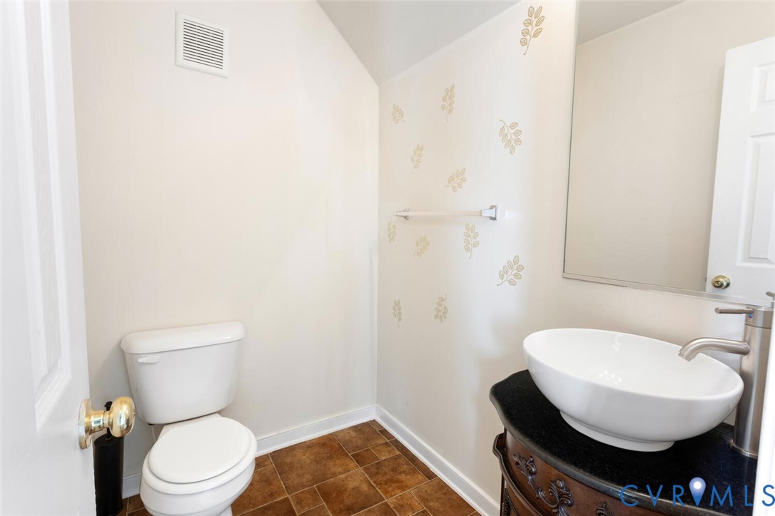 15650 River Road Chesterfield, VA 23838 - Photo 25 of 50 a bathroom with a toilet a sink and mirror