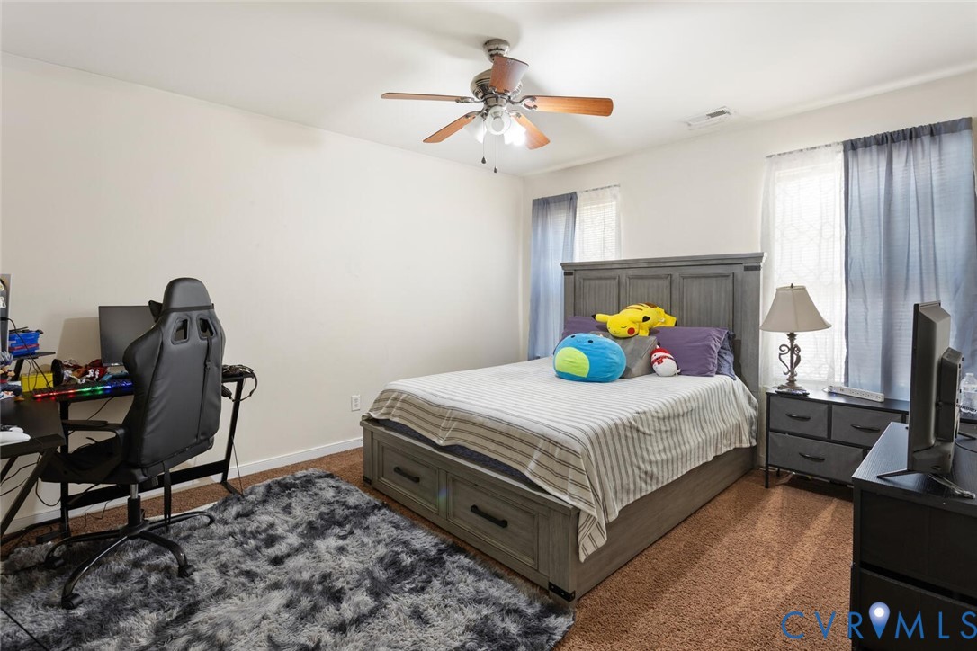 15650 River Road Chesterfield, VA 23838 - Photo 38 of 50 a bedroom with a bed a dresser and chair