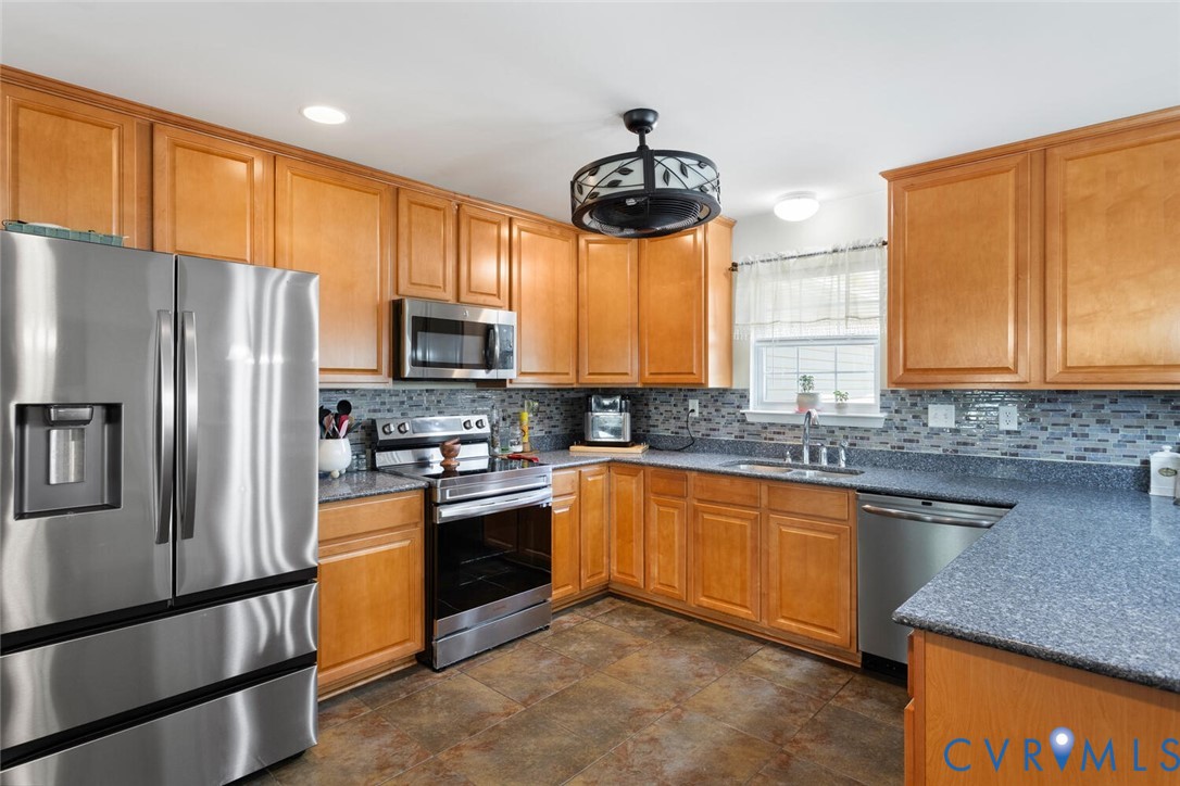 15650 River Road Chesterfield, VA 23838 - Photo 10 of 50 a kitchen with stainless steel appliances granite countertop a stove refrigerator sink and microwave