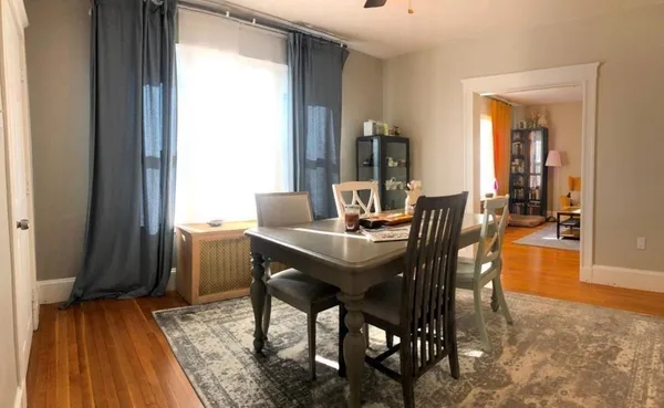 a view of a dining room with furniture and wooden floor