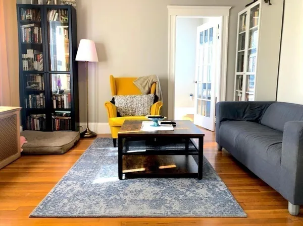 a living room with furniture rug and window