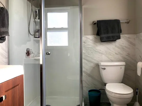 a bathroom with a toilet and a shower