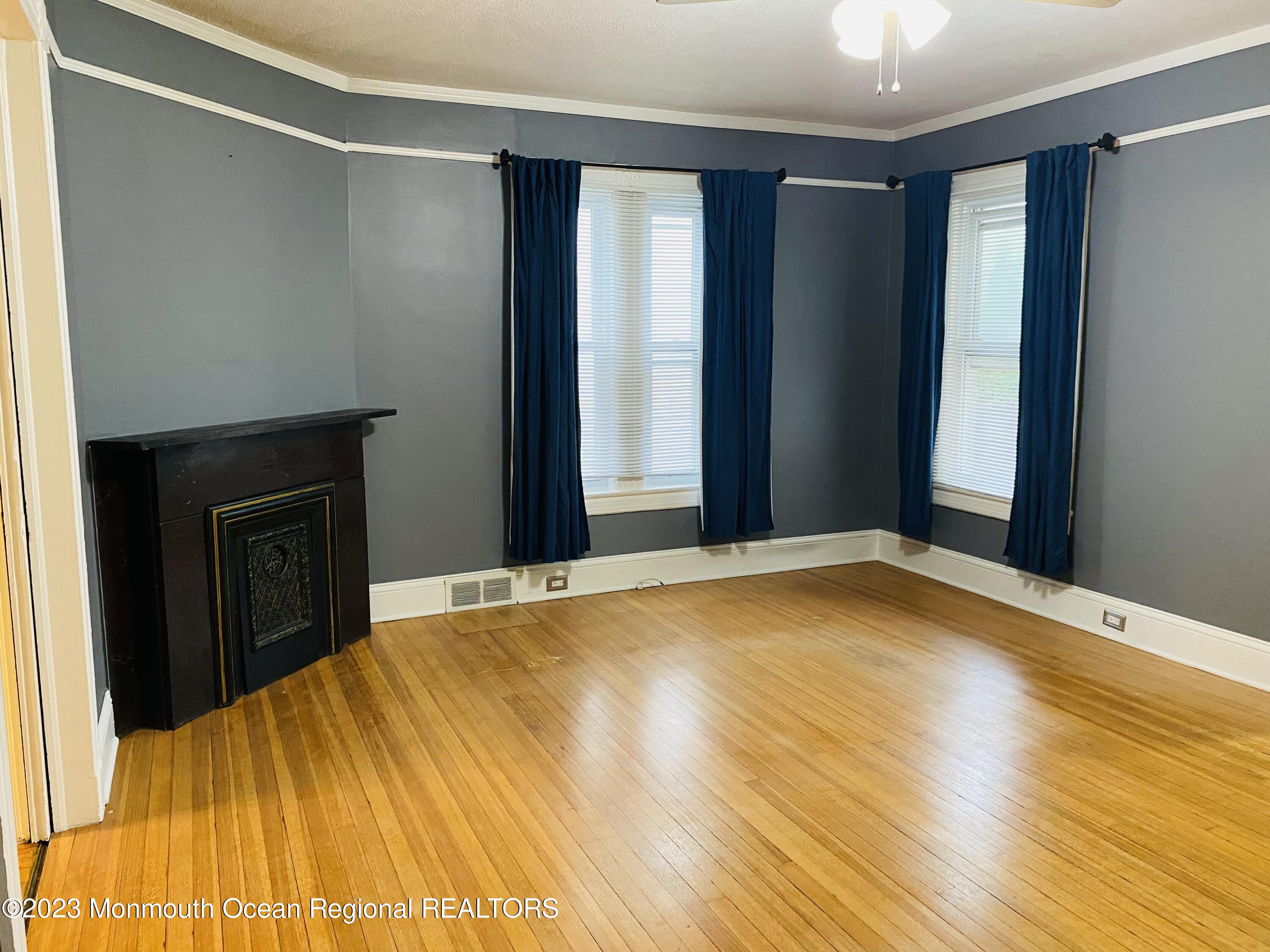 24-26 Rector Place Red Bank, NJ 07701 - Photo 3 of 6 a bedroom with a bed and a window