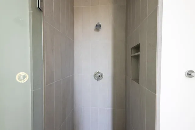 a view of a balcony with wooden floor and iron stairs