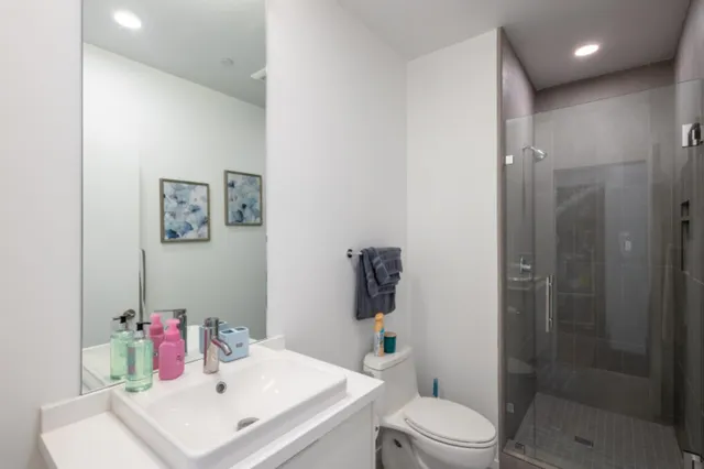 a bathroom with a sink toilet and shower