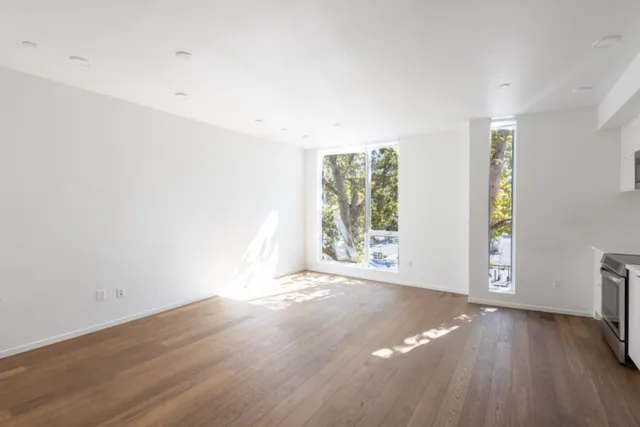 a view of a kitchen with wooden floor and a fireplace