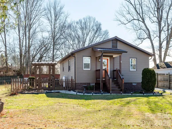 a view of a house with swimming pool and furniture