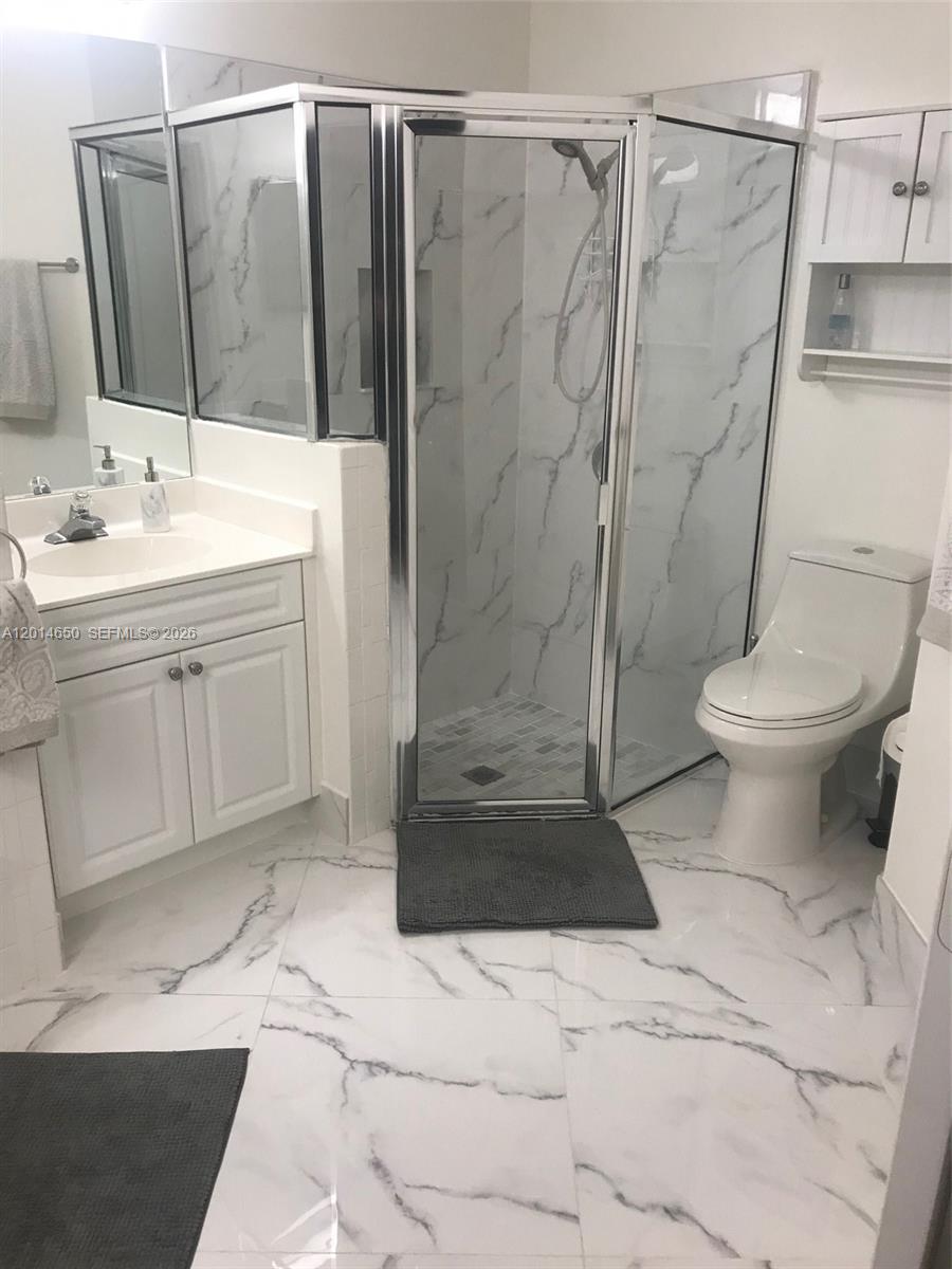 16654 Southwest 103rd Lane Miami, FL 33196 - Photo 15 of 20 a bathroom with a sink a toilet and shower