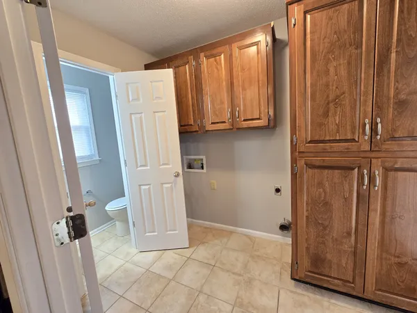 a view of a storage and utility room with wooden walls