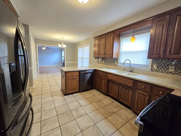 a kitchen with stainless steel appliances a sink stove and cabinets