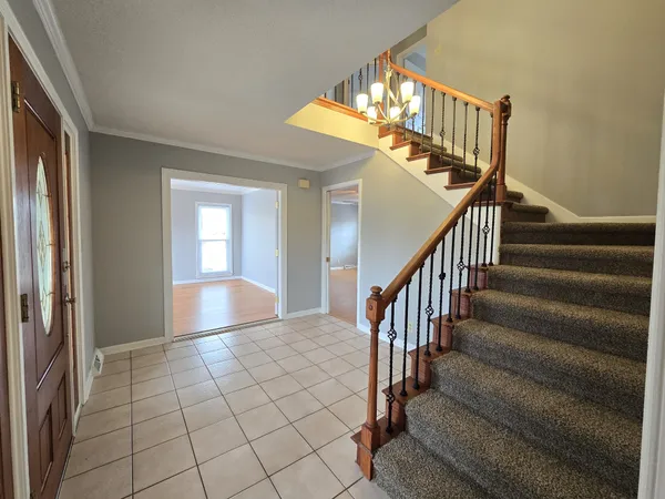 a view of entryway and hall with wooden floor