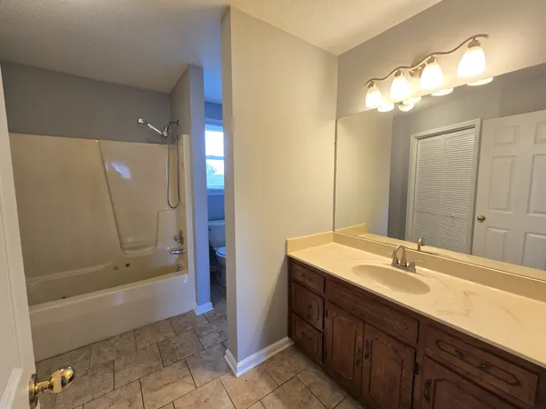 a bathroom with a sink a shower and a mirror