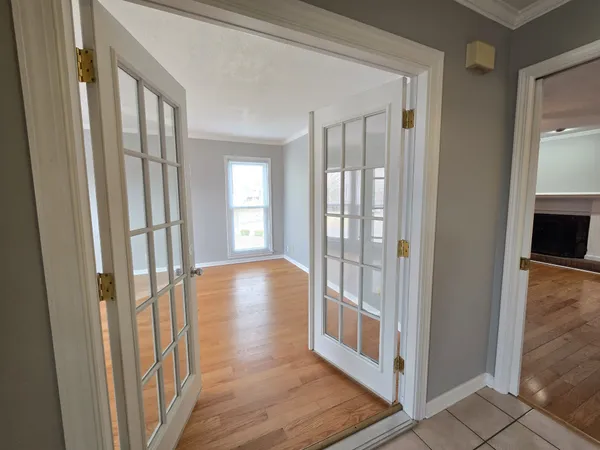 a view of an entryway with wooden floor and a livingroom