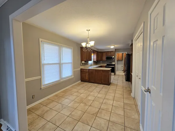 a kitchen with granite countertop a sink cabinets and stainless steel appliances