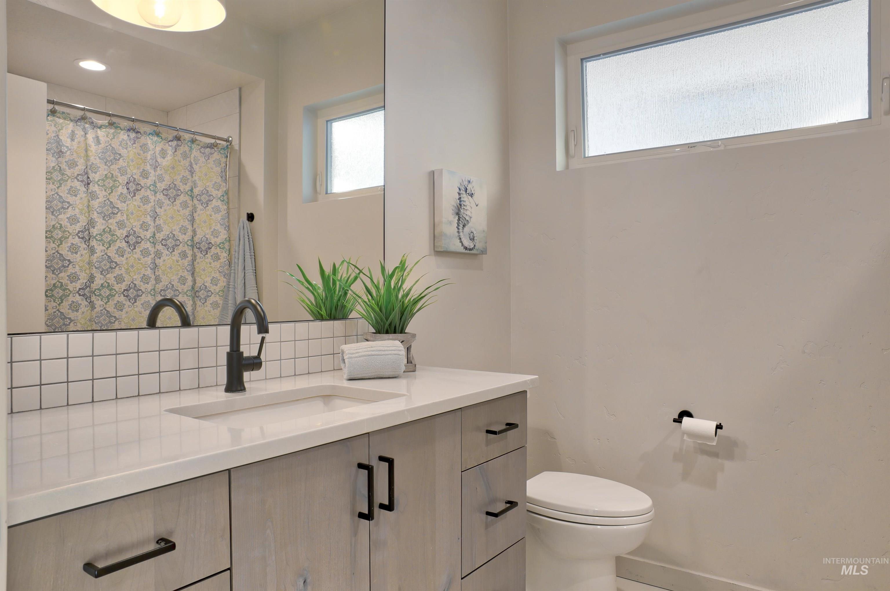4148 East Copper Point Drive Meridian, ID 83642 - Photo 15 of 26 Full bathroom featuring vanity and curtained shower