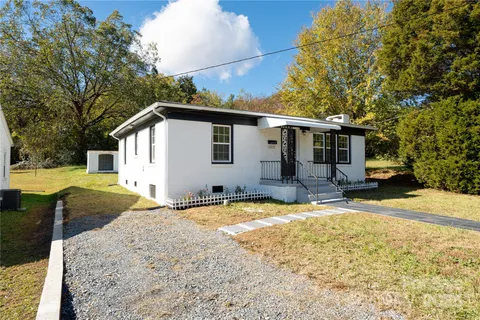 a view of a house with swimming pool and sitting area