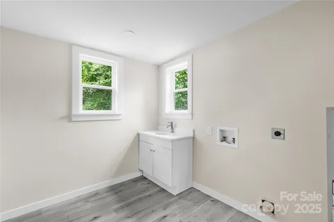an empty room with a window and wooden floor