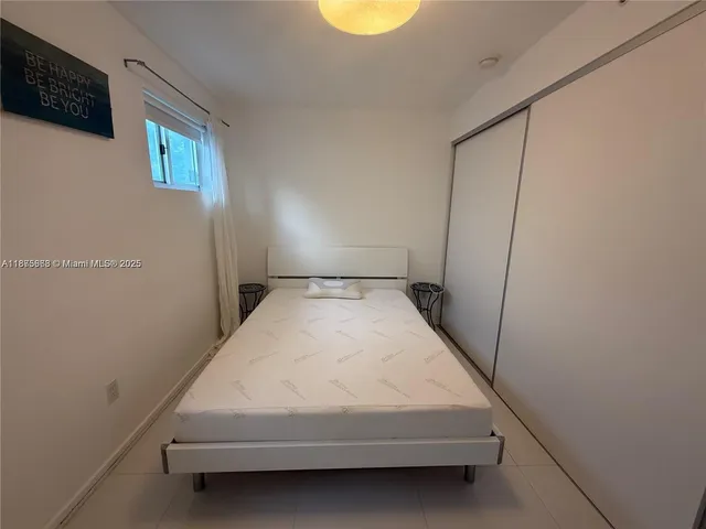 a bedroom with a bed and cabinets