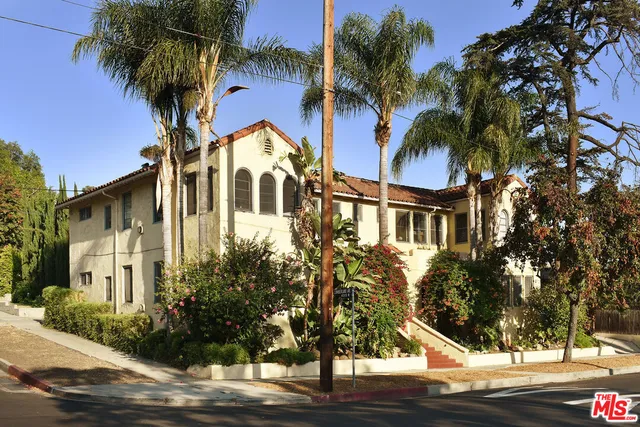 a front view of a house with a yard and balcony